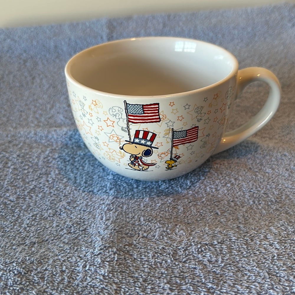 Peanuts soup container, or oversized coffee cup.
